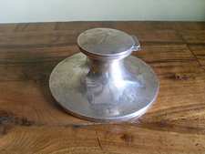A silver capstan inkwell