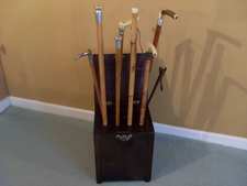 A collection of walking canes in a stand