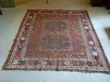 A rectangular antique Caucasian rug