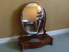 A Regency serpentine toilet mirror