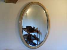 An antique oval wall mirror