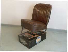 A vintage car seat and mechanics box