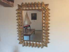 A Spanish metal leaf mirror