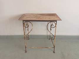An iron scrollwork side table