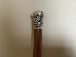 A silver topped walking cane