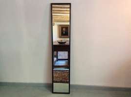 A tall narrow dressing mirror