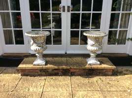 A pair of large cast iron urns