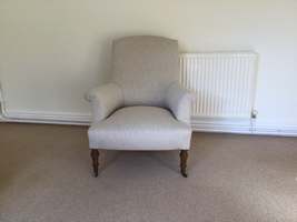 A fawn linen french armchair