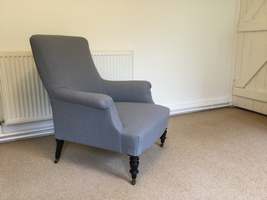 A grey linen French armchair